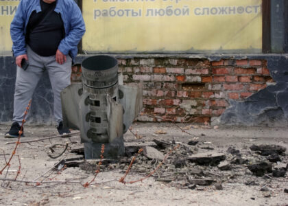 An unexploded rocket close to a floors building sticks out of a ground.Approaching explosive objects is dangerous to life. Prompt transfer of missile hit sites to social networks is prohibited by law. An unexploded rocket close to a floors building sticks out of a ground.Approaching explosive objects is dangerous to life. Prompt transfer of missile hit sites to social networks is prohibited by law.